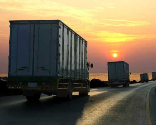 Truck on highway road with container, transportation concept.,import,export logistic industrial Transporting Land transport on asphalt expressway with sunrise sky